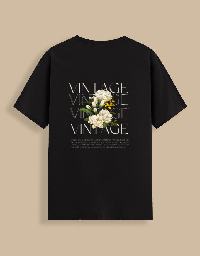 Black t-shirt with floral design and 'VINTAGE' text on a beige background