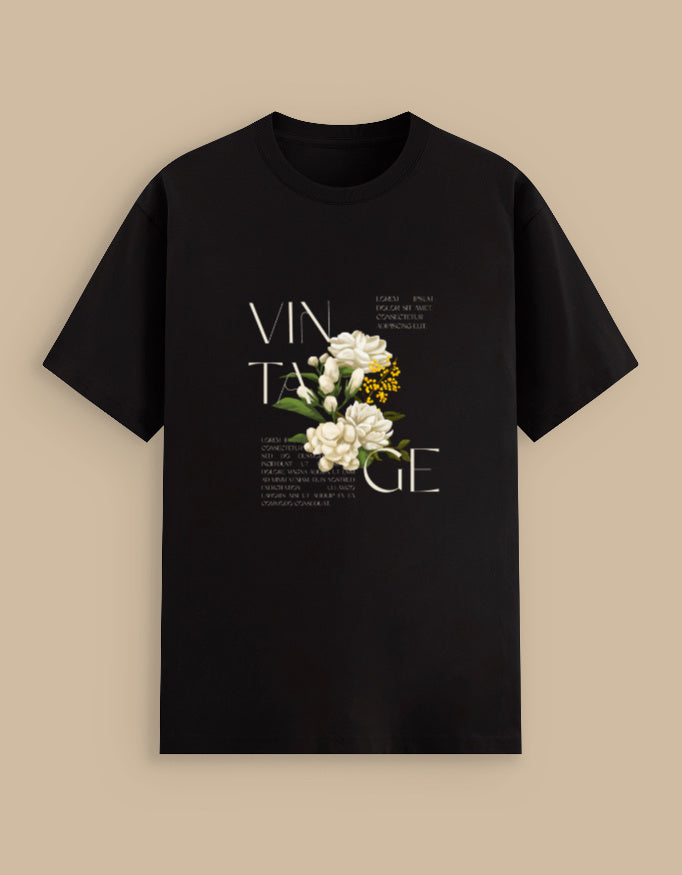 Black t-shirt with floral design and 'VINTAGE' text on a beige background