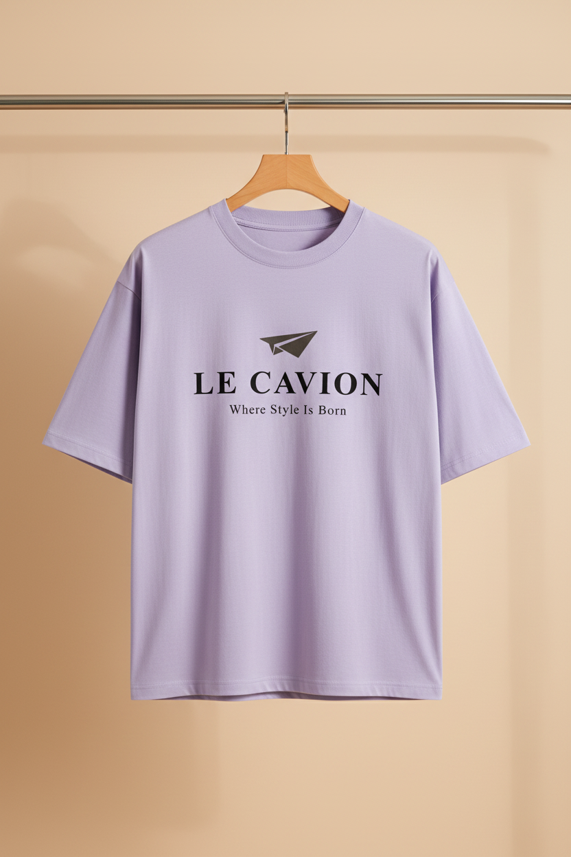 Lavender t-shirt with 'LE CAVION' logo on a wooden hanger against a beige background