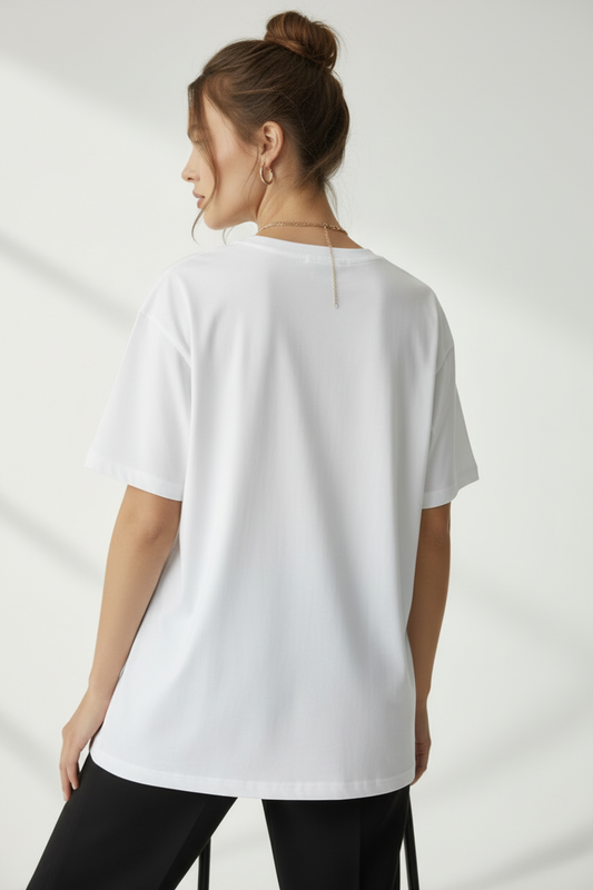 Woman wearing a white t-shirt against a plain background